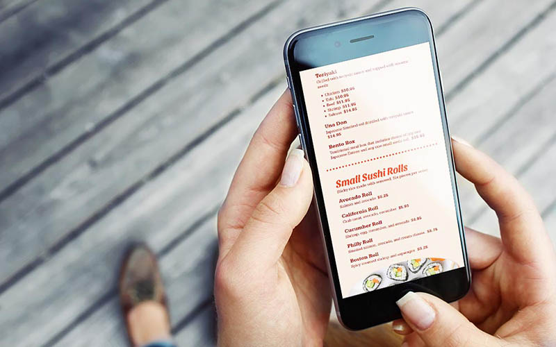 a hand holding a black Iphone with a chinese food menu on the screen.