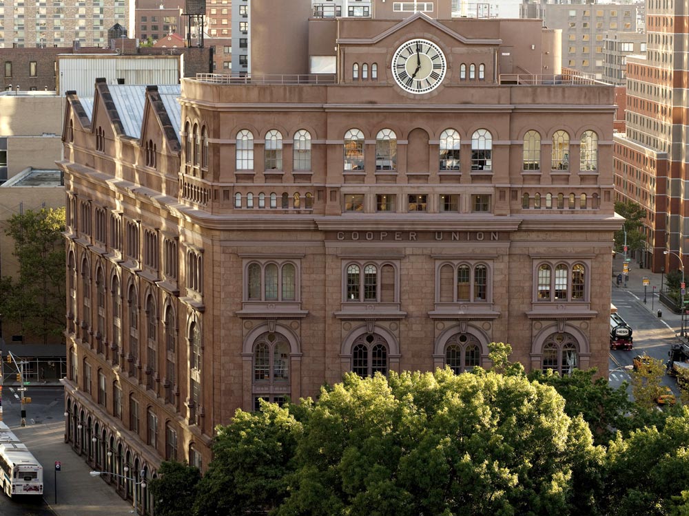 tan brick building with clock in the center